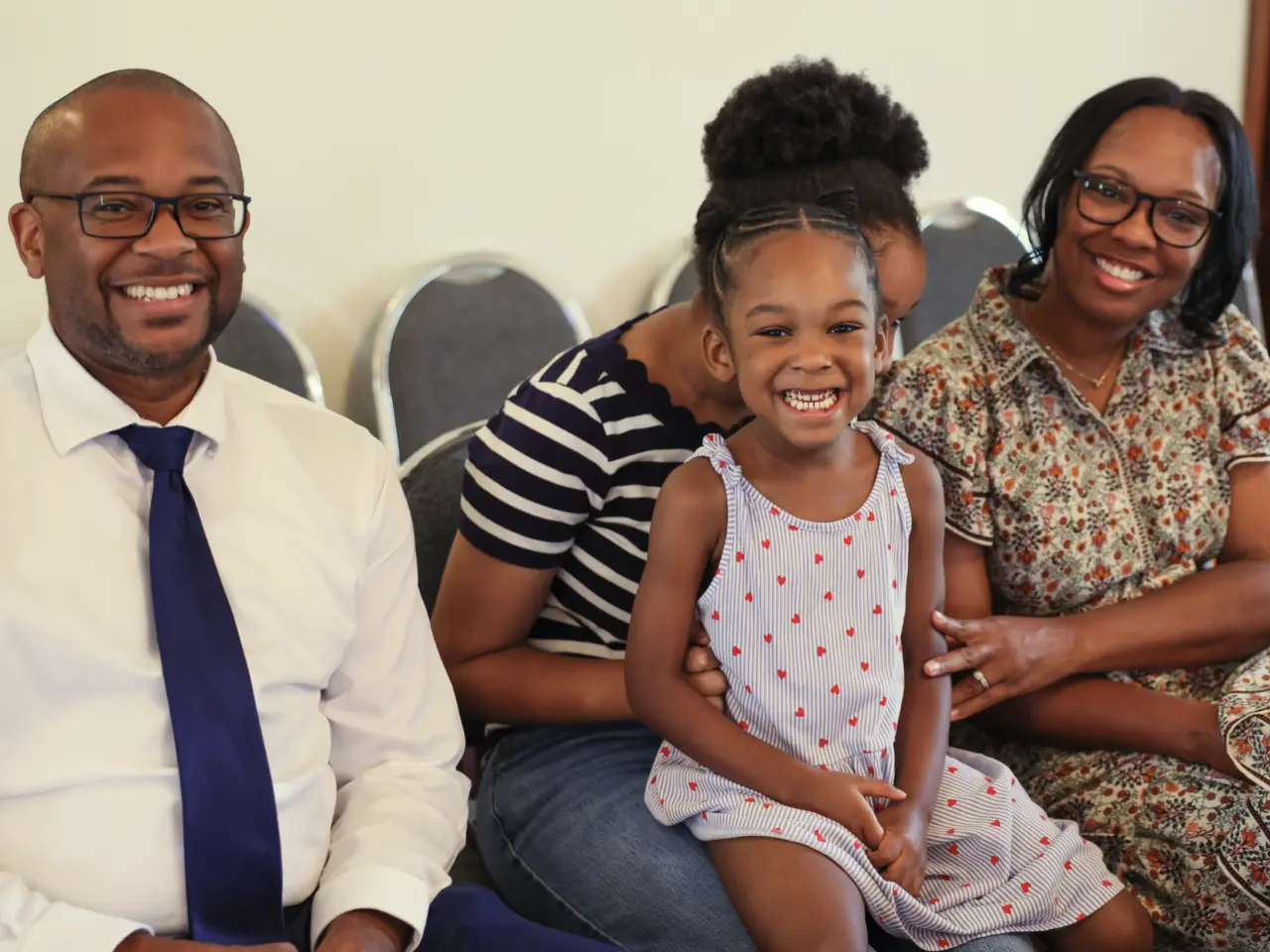 Family smiling looking at camera