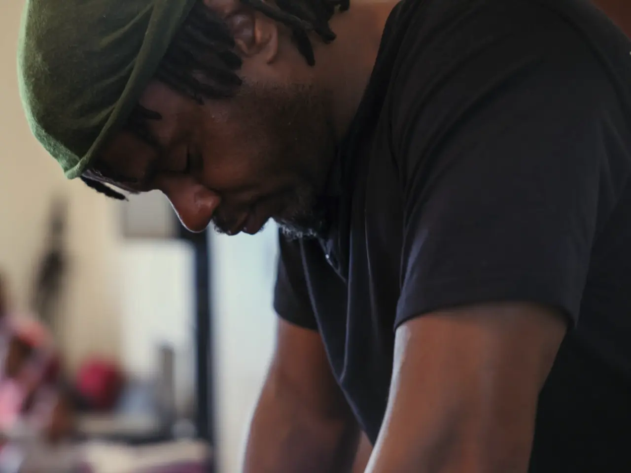 Man with head bowed down praying